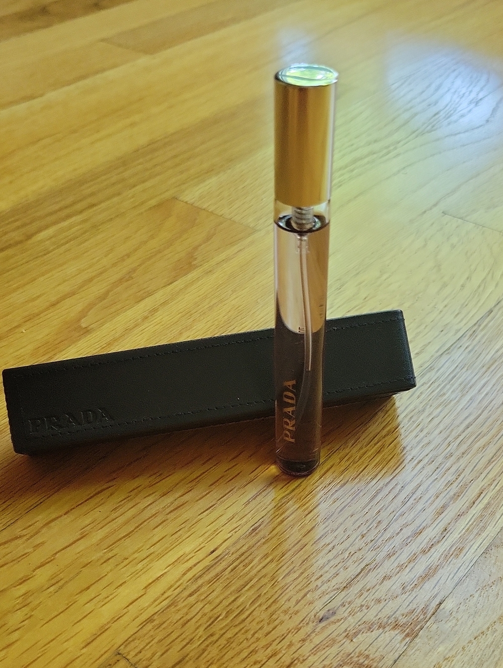 Prada Rollerball Perfume — Amber Liquid with Gold Cap and Black Sleeve